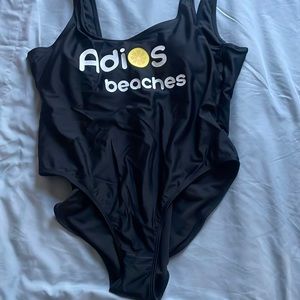 Black xl swimsuit. Says; adios beaches. Never worn. Nwt and panty guard inside
